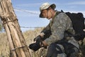 Soldier Cutting Barbed Wire Fence