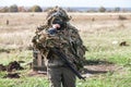 Soldier in a field camouflage with an automatic rifle before a fight