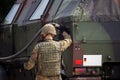 Soldier fuels a military armored truck