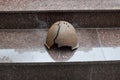 Soldier full of helmets of World War II at monument to the memory of fallen soldiers