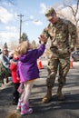 Soldier gives little girl high five at a Veterans Day celebration