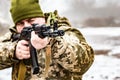 A soldier with a gun AKM, aims at the enemy. Barrel and muzzle machine close up