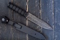 Soldier knife. Knife for the military. Black knife and black plastic sheath. Top view. Royalty Free Stock Photo