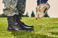 Soldier in leather boots and girl in sandals. Royalty Free Stock Photo