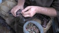 Soldier loading a bunch of bullets into a handgun magazine.