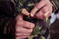 Soldier loading a 9mm caliber cartridge