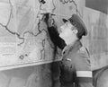 Soldier looking at a map marking it with a pen Royalty Free Stock Photo