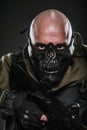 Soldier military man in a black mask on a dark background.