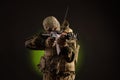 Soldier militia saboteur in military clothing with a Kalashnikov rifle on a dark background