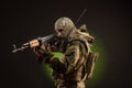 Soldier militia saboteur in military clothing with a Kalashnikov rifle on a dark background Royalty Free Stock Photo