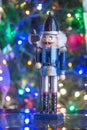 Soldier nutcracker statue standing in front of decorated Christmas tree Royalty Free Stock Photo