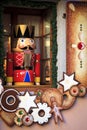 Soldier nutcracker statue standing in front of a decorated Christmas window Royalty Free Stock Photo