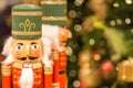 Soldier nutcracker statues standing in front of decorated Christmas tree with bokeh lights Royalty Free Stock Photo