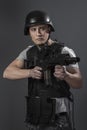 Soldier, paintball sport player wearing protective helmet aiming