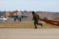 Soldier picks up dropped parachute of Sukhoi Su-25 airplane of Russian air force during Victory Day parade rehearsal