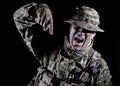 Soldier pointing finger down on black background