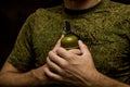 soldier presses a grenade to the brisket, self-sacrifice and heroism in war. frag grenade in hand