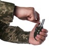 Soldier pulling safety pin out of hand grenade on white background, closeup Royalty Free Stock Photo