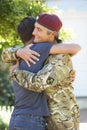 Soldier Returning Home And Greeted By Teenage Son