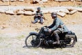 A soldier rides a motorbike. Royalty Free Stock Photo