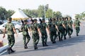 soldier with rifle gun long range patrolling on city. Group of Soldiers marching on the asphalt road. The security unit is checkin