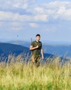 Soldier with rifle. Man with weapon military clothes in field nature background. Army forces. State border guard service Royalty Free Stock Photo