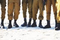 The soldier`s footwear of the Israeli army which is put on legs in clear sunny day. Royalty Free Stock Photo