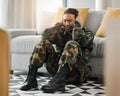 Soldier, sad and ptsd with man in living room for depression, stress and psychology. Army, military and war veteran with