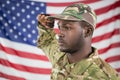 Soldier saluting against american flag