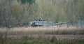 Soldier in a tank surrounded by trees