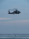 Soldier rescue demonstration with a helicopter at sunset Royalty Free Stock Photo