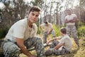 Soldier tying his shoe laces in boot camp Royalty Free Stock Photo