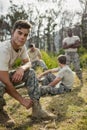 Soldier tying his shoe laces in boot camp Royalty Free Stock Photo