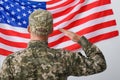 Soldier in uniform and United states of America flag on white background, back view Royalty Free Stock Photo