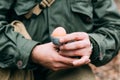 Soldier Of USA Infantry Of World War II Holds Egg Holder In Hands During Breakfast. Royalty Free Stock Photo