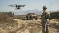 Soldier uses modern drone for surveillance, military man controls uav during training or war. Concept of army, intelligence, Royalty Free Stock Photo