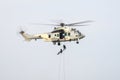 Soldier using rope going down to attack from military helicopter Royalty Free Stock Photo