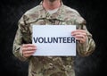 Soldier volunteer mid section against black grunge background