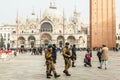 Soldier walk with view of famous San Marco basilica at Venice,Italy.