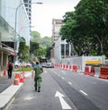 A soldier walking on street in Singapore