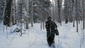 Soldier with weapons in cold forest. Winter warfare and military concept. Clip. Soldiers in winter forest on skis with Royalty Free Stock Photo