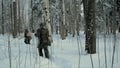 Soldier with weapons in cold forest. Winter warfare and military concept. Clip. Soldiers in winter forest on skis with Royalty Free Stock Photo