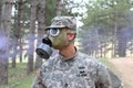 Soldier wearing gas mask in the forest