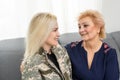 Soldier woman returning home to her family, embracing his mother, close up Royalty Free Stock Photo