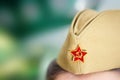 A soldier& x27;s cap with the emblem of a red star, hammer and sickle, worn in honor of the Great Victory Day on May 9 Royalty Free Stock Photo