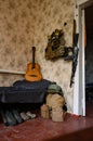 A soldier's combat military assault rifles AK 74 and military ammunition next to a guitar