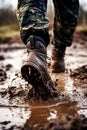 The soldier& x27;s feet walk through the mud. Selective focus.