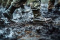 soldiers boots trudging through thick mud in a military training camp Royalty Free Stock Photo