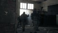 Soldiers in camouflage with combat weapons sneak along the corridors of the old building, the military concept Royalty Free Stock Photo