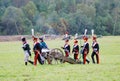 Soldiers carry a cannon